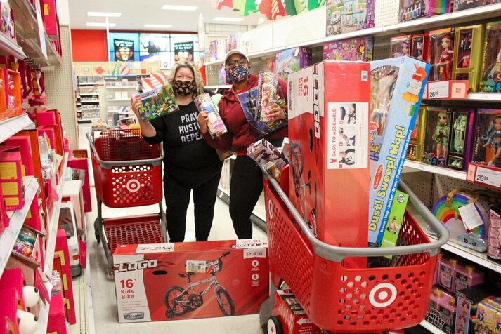Ramona B. and Christi B. share some of their toy finds while shopping for families in need
