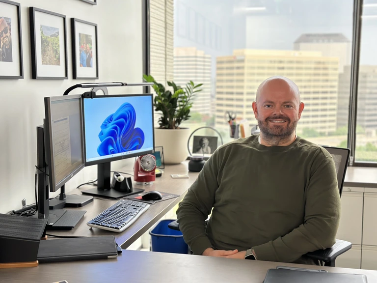 Chris Hughes sitting at his desk