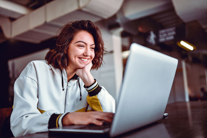 Woman looking at paystub on laptop